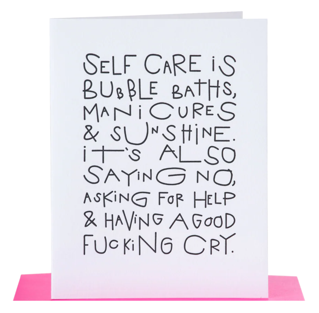 White greeting card with black text about self care paired with a hot pink envelope