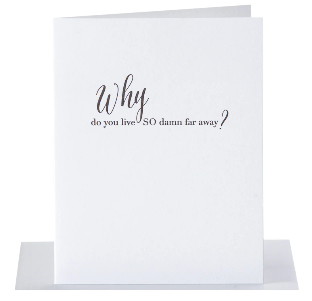 White greeting card with black text that reads why do you live so damn far away?" paired with a metalic silver envelope
