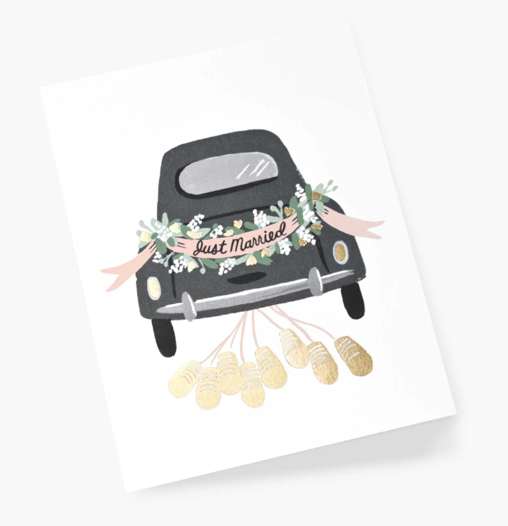 greeting card with an illustration of the back of a black vintage car with floral decorations and a &