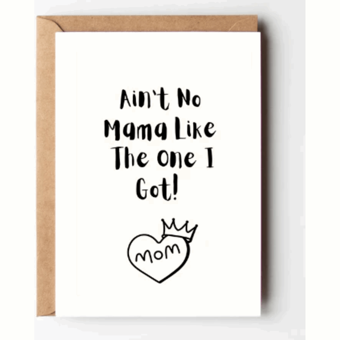 A white greeting card featuring black text that reads 'Ain't No Mama Like The One I Got!' and a heart illustration with crown below the text. The card also includes a kraft brown envelope.