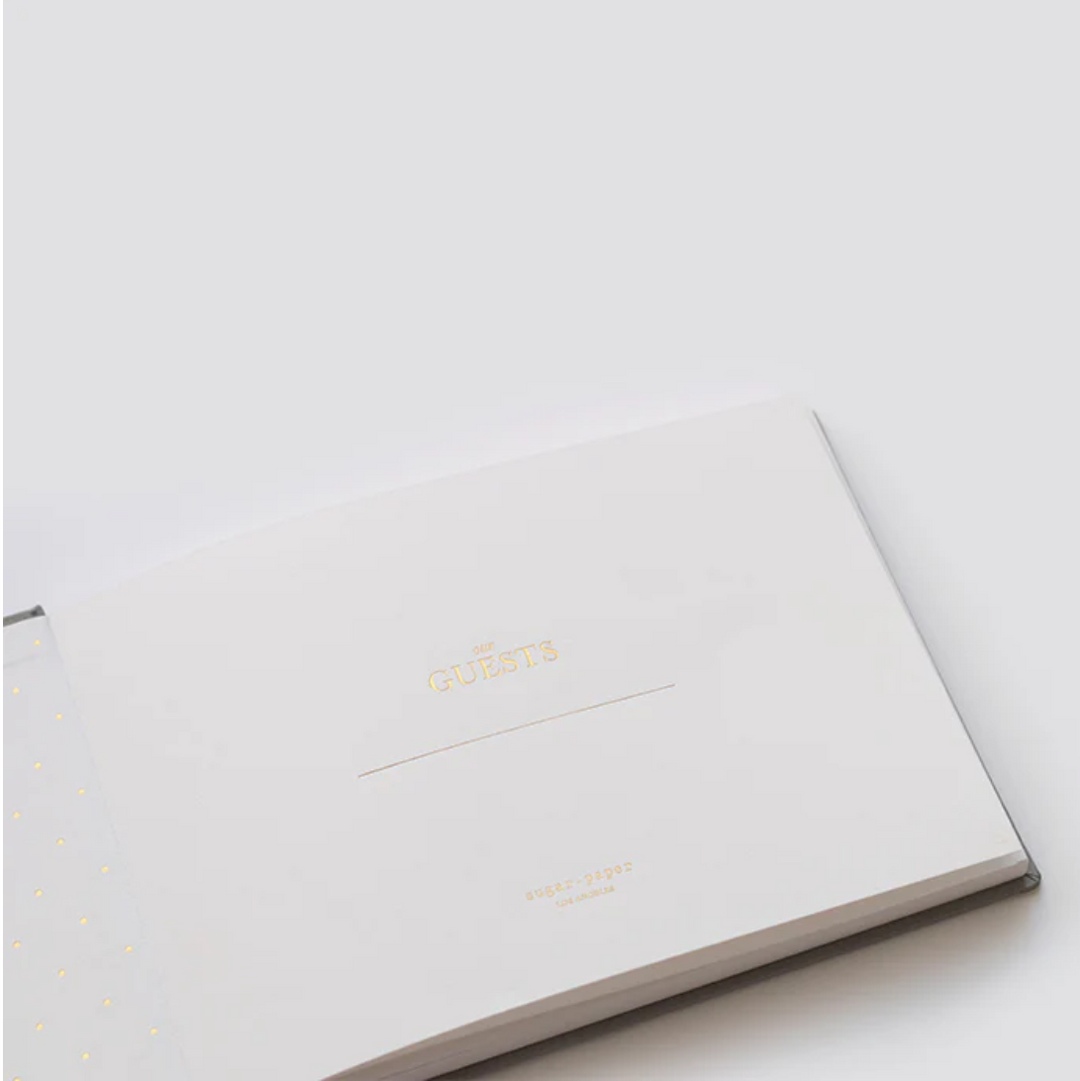 White notebook with gold text on a light gray background