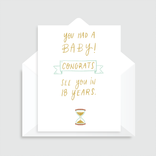 White greeting card with green text that reads "You had a baby! Congrats, See you in 18 years" with an illustrated hourglass, paired with a white envelope