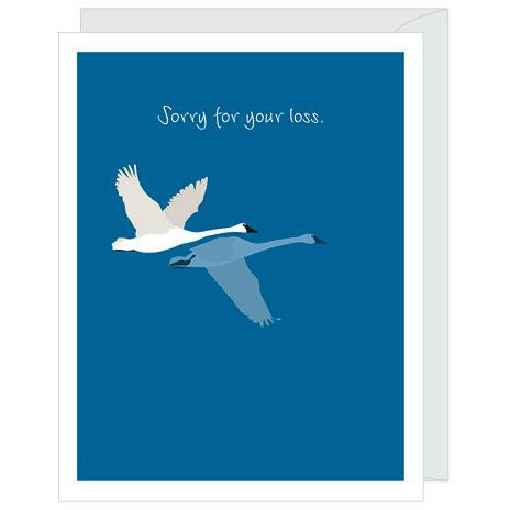 A deep blue greeting card featuring an illustration of a white and a blue swan in flight, with the text "Sorry for your loss" paired with white envelope