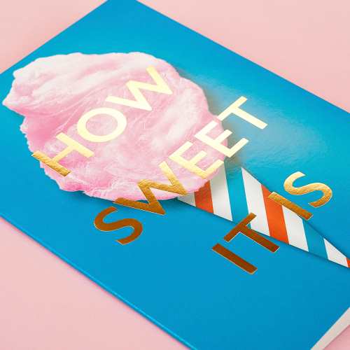 Teal greeting card with an image of cotton candy on a teal, red, and white striped cone, and gold-foil text "ow Sweet It Is"