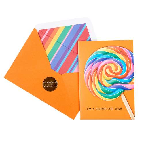 Vibrant orange greeting card with a large rainbow swirl lollipop with gold-foil text reads "I&