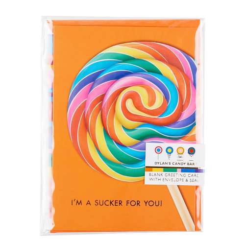Packaged vibrant orange greeting card with a large rainbow swirl lollipop with gold-foil text reads "I'm a sucker for you!"