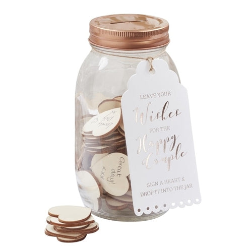 A clear glass mason-style jar with a rose gold lid, labeled &