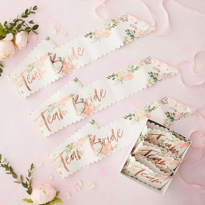 Three paper sashes with floral patterns and &
