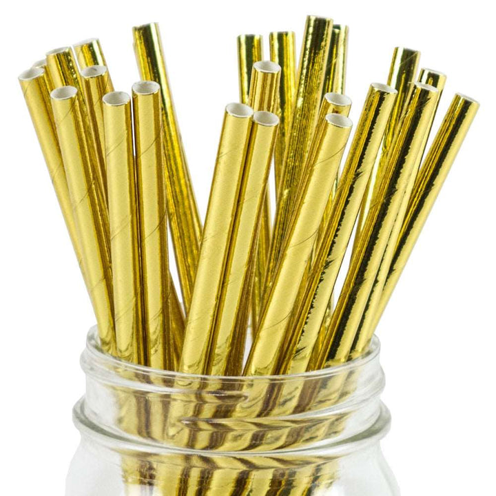 An image of gold foil paper straws in a glass mason style jar
