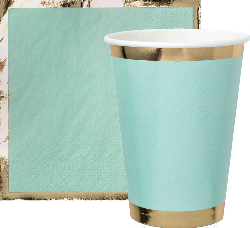 A mint green paper cup with gold foil borders and a mint green paper napkin with gold foil borders against a white background
