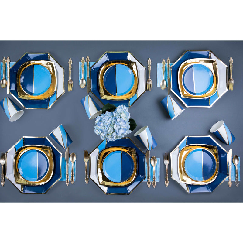 Navy, light blue, white, and gold place setting using paper charger plates, dinner and dessert plates, cups and gold utensils