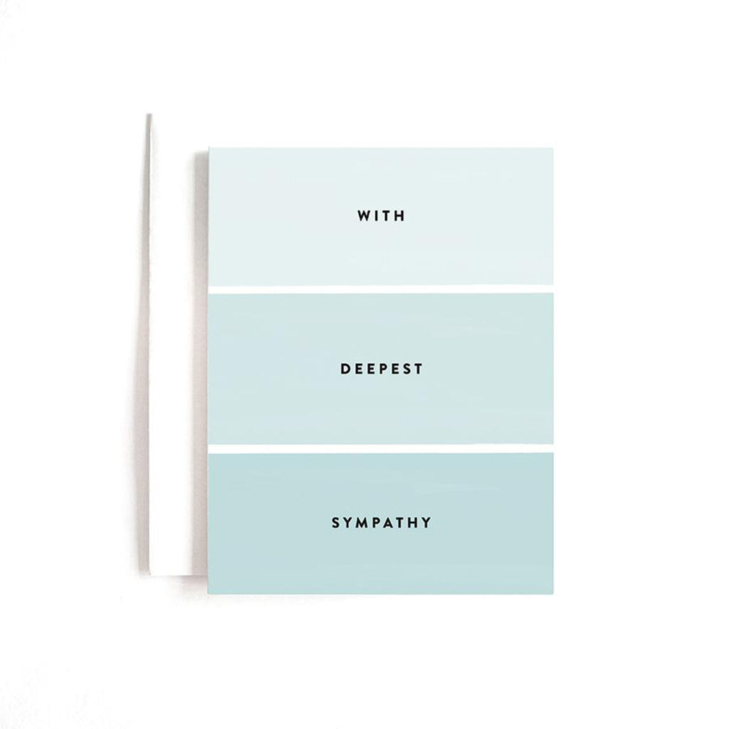 Tonal, color blocked blue greeting card with text that reads "with deepest sympathy" and a white envelope