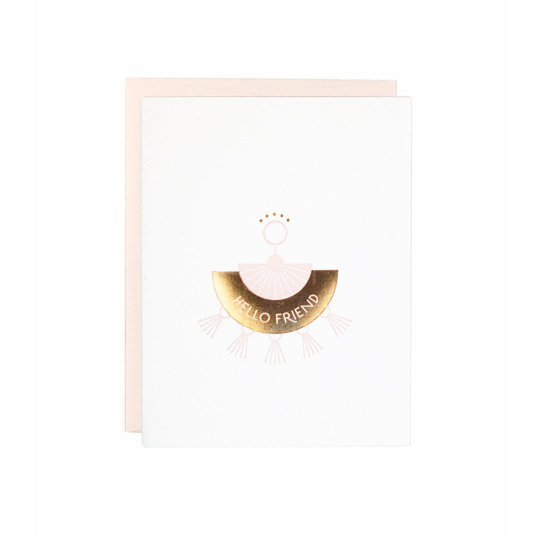 White greeting card, with a pink and gold foil letterpress tassel style earring with the text "Hello Friend" with a blush pink envelope