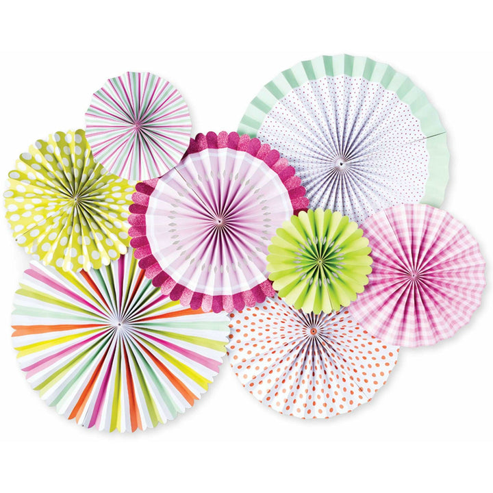 A collection of colorful paper fans in varying pastel and neon patterns in different sizes, displayed against a white wall.