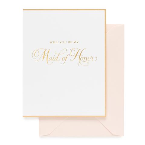A white greeting card with gold foil "Will You Be my Maid of Honor" text and border. Paired with a blush pink envelope.