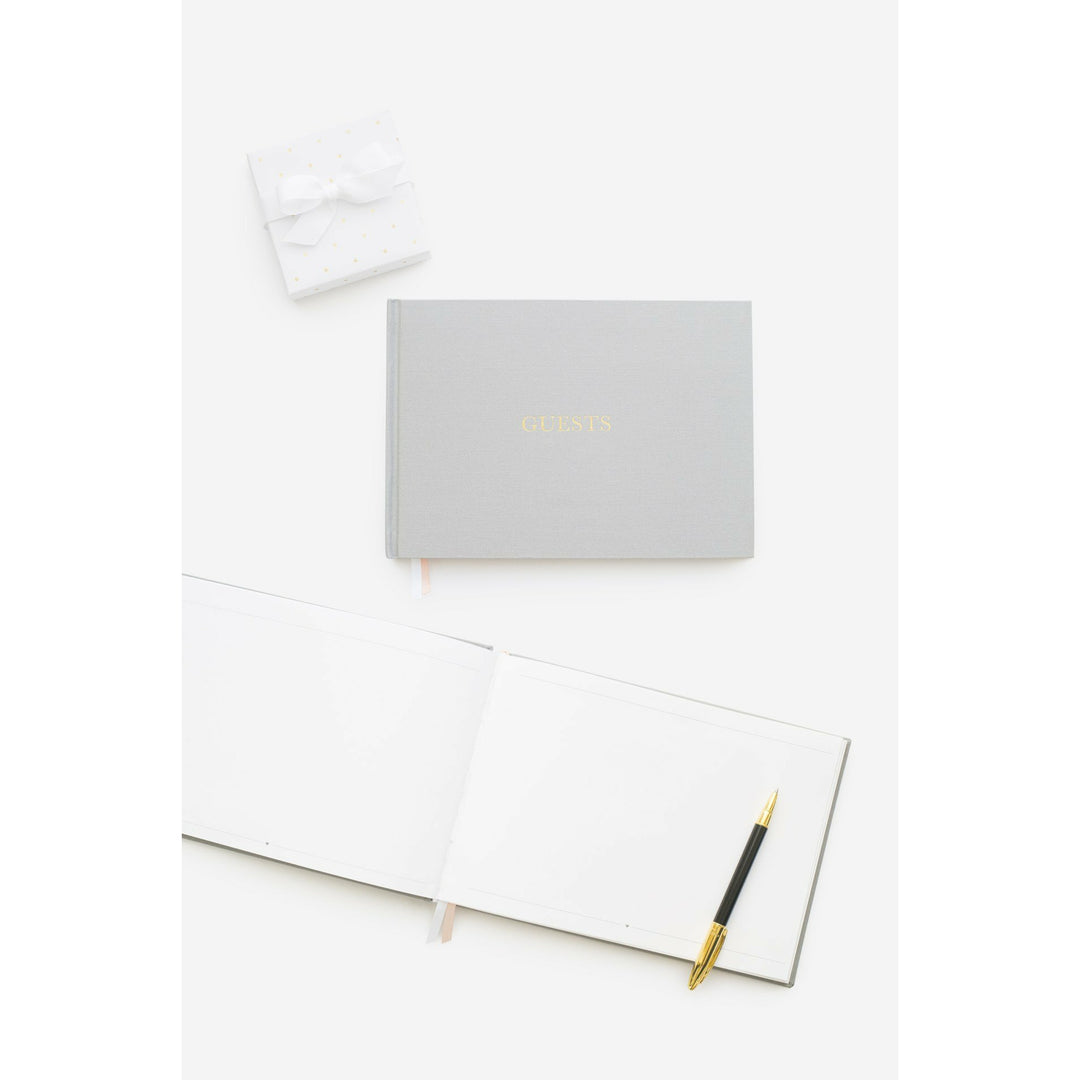 Grey color fabric bookcloth covered guest book with the word guest in gold foil print