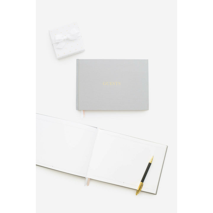 Grey color fabric bookcloth covered guest book with the word guest in gold foil print