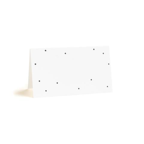 A white place card with a matte black printed dot pattern, displayed in a tent-style fold.